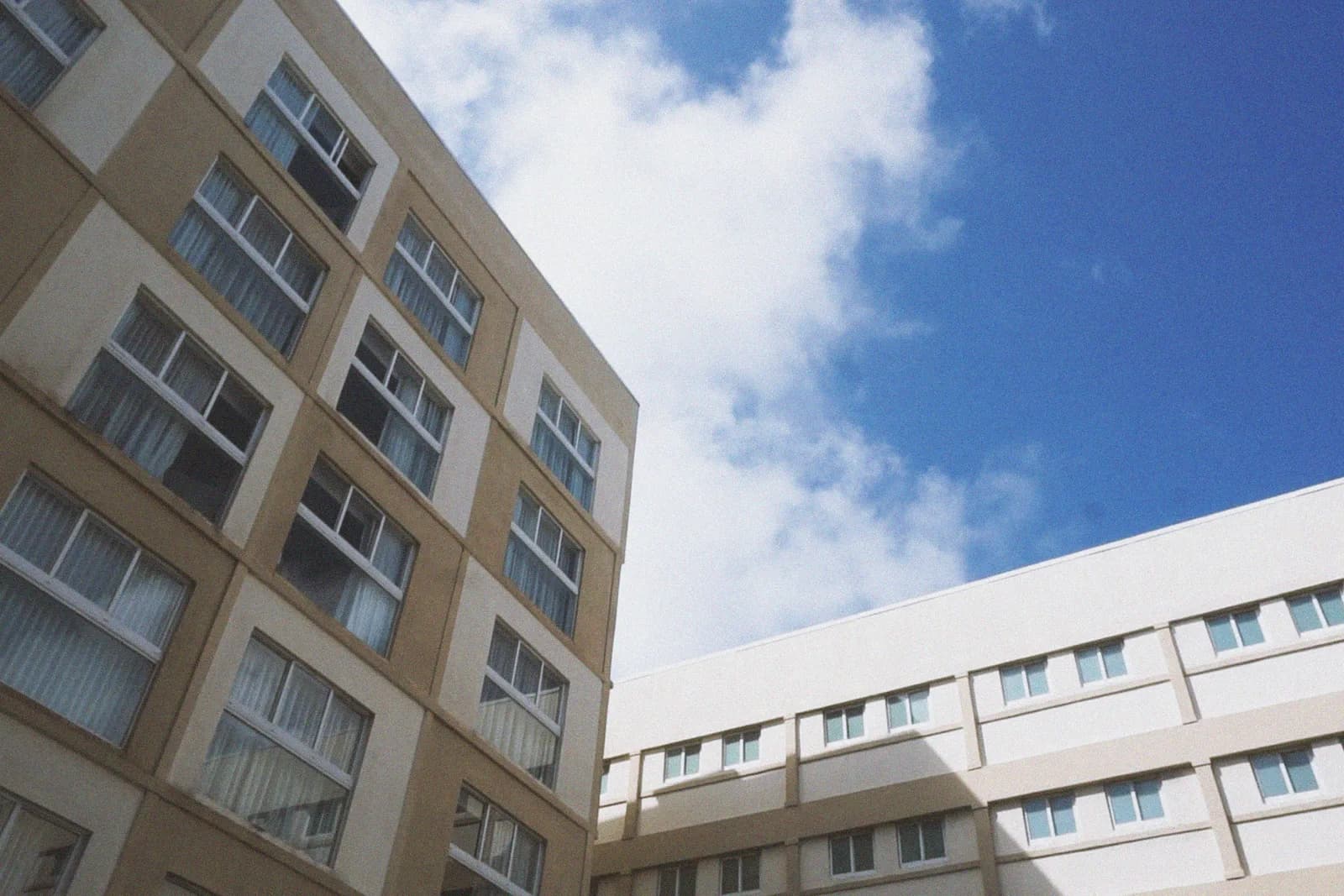 青空を背景に見上げた完成したばかりの集合住宅の外壁